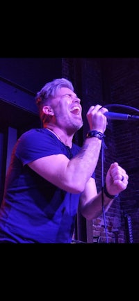 a man singing into a microphone